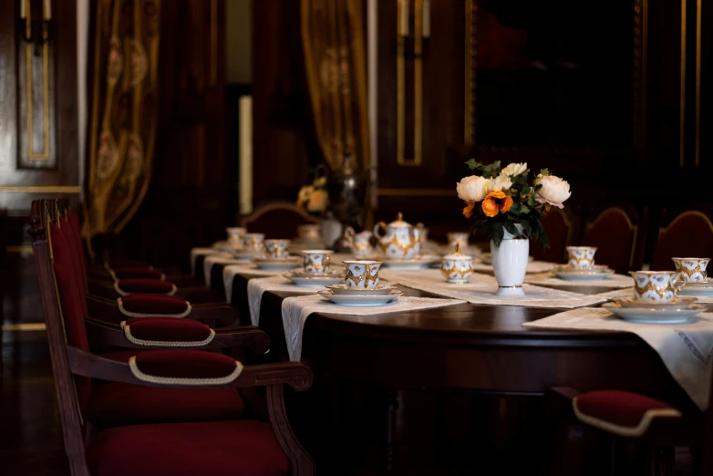 an elegant set table with four different color chairs