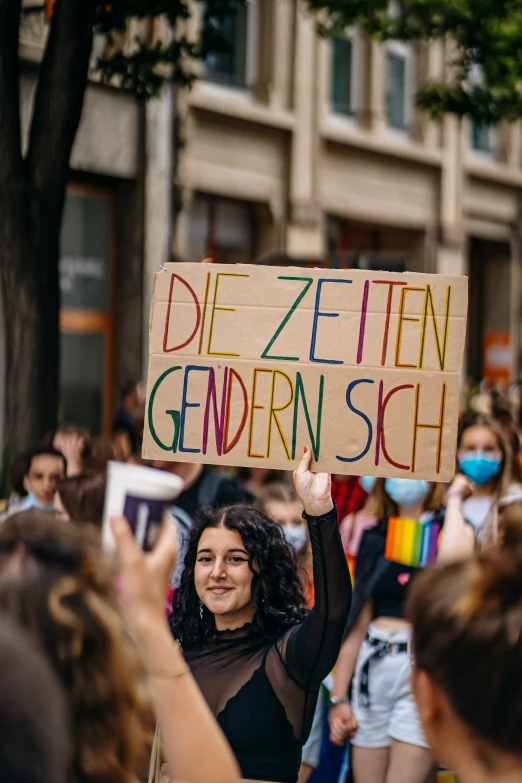 a person holding up a sign in the street