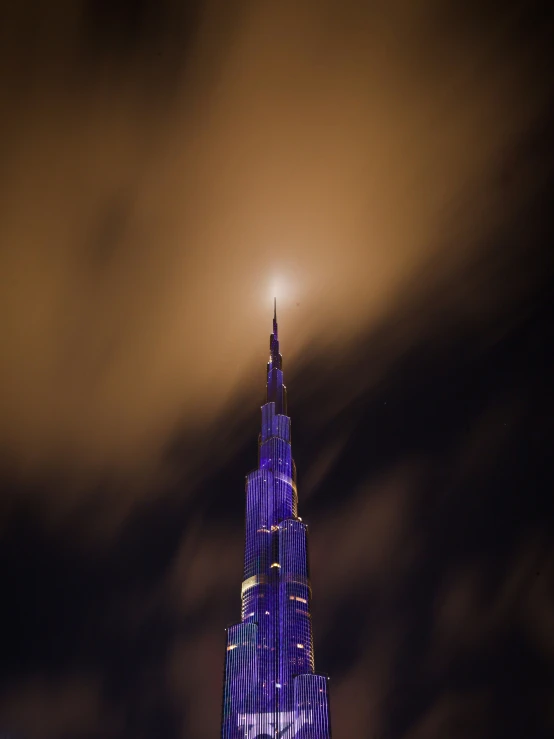 a tall building stands under a cloudy sky