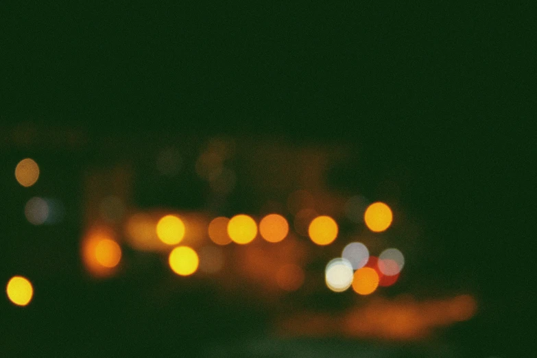 a blurry city street lights are in the dark