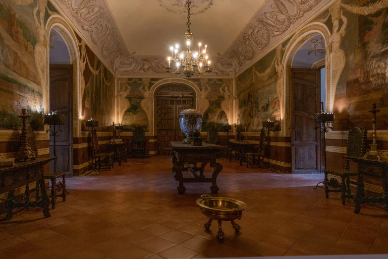 a fancy dining hall with chandeliers, tables and windows