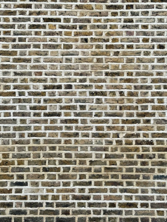 a brick wall with vertical ridges in grey and white