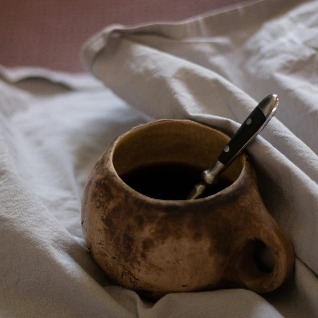 an old coffee cup is left on the bed