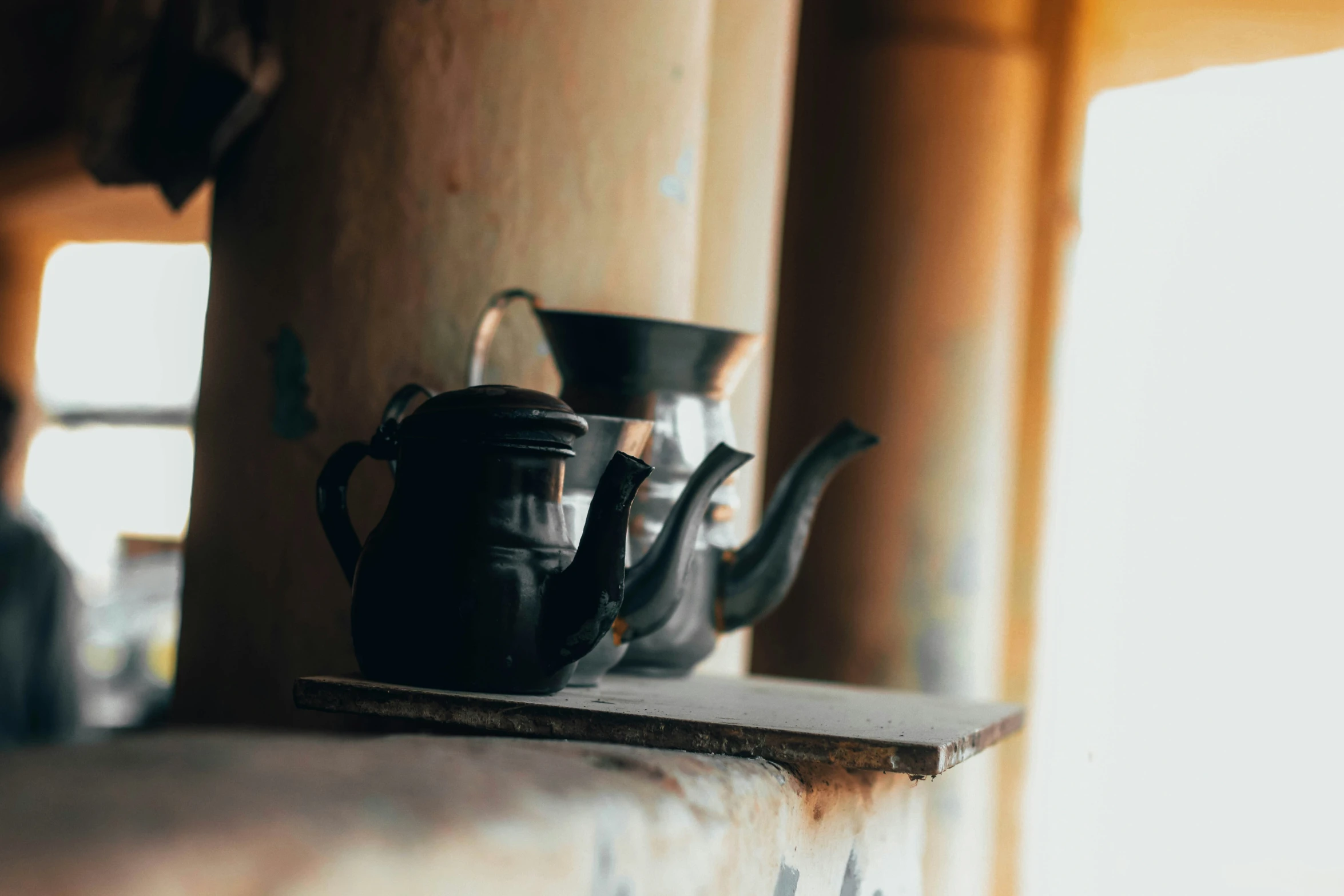 a bunch of teapots and a kettle sitting on a table