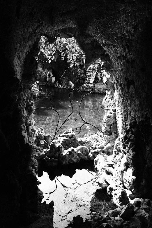 water inside of a well lit cave with a person in it