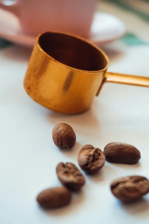 a wooden spoon that is in the middle of nuts