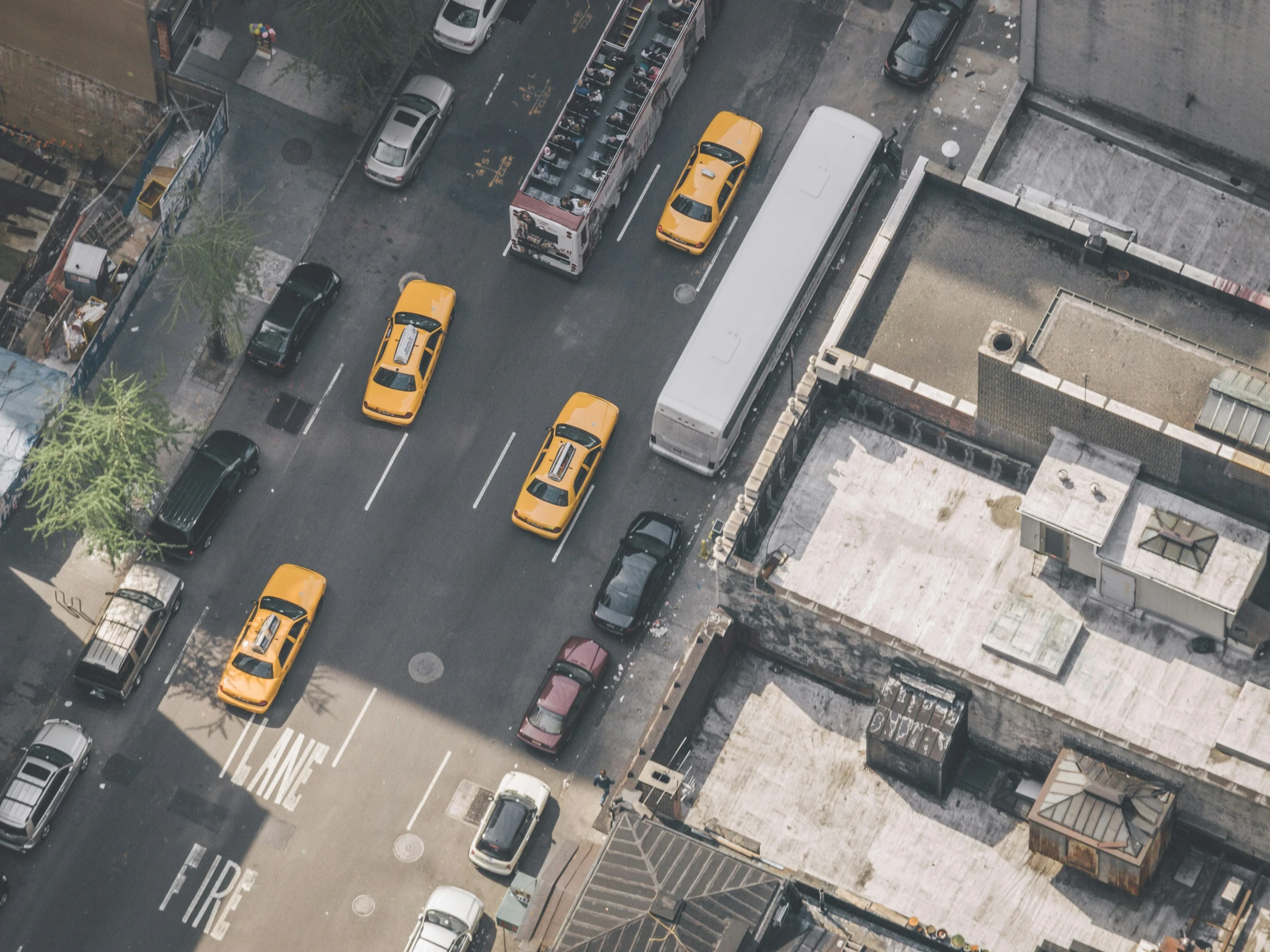 aerial view of a parking lot full of yellow taxis