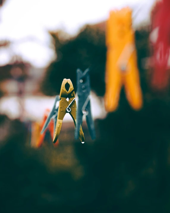 small yellow scissors in the foreground and an orange one above