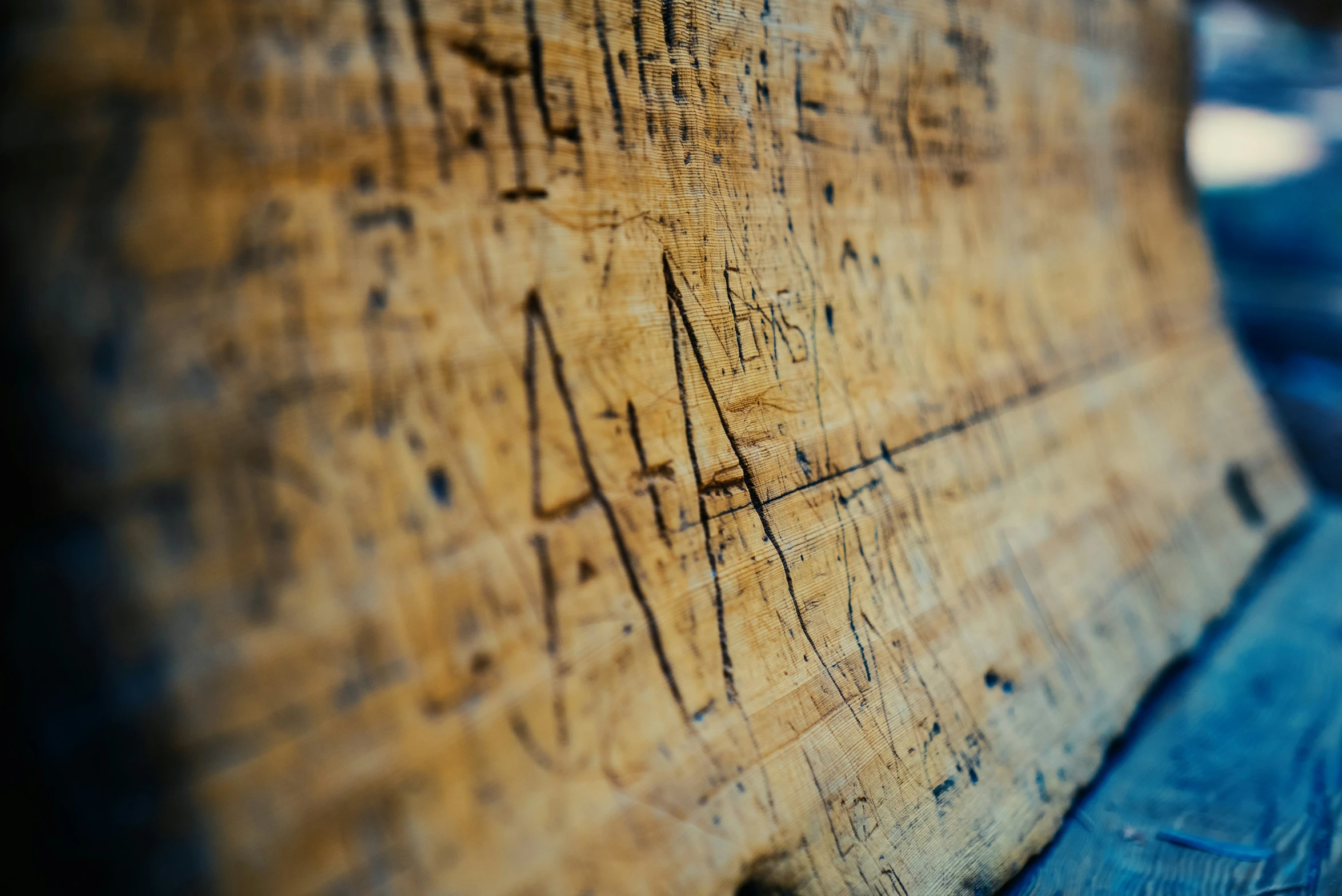 a wood sign sitting on top of a wooden table