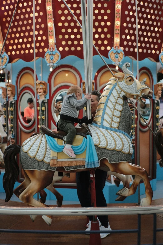 the man is riding the carousel horse during the show