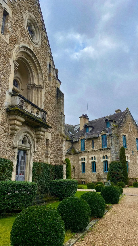 an image of front view of mansion and landscaping