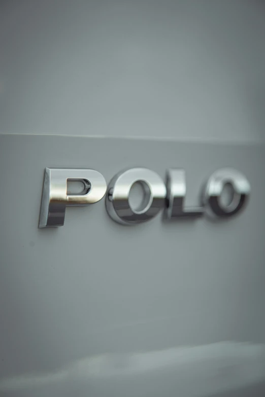 a silver polo car emblem that is made out of metal