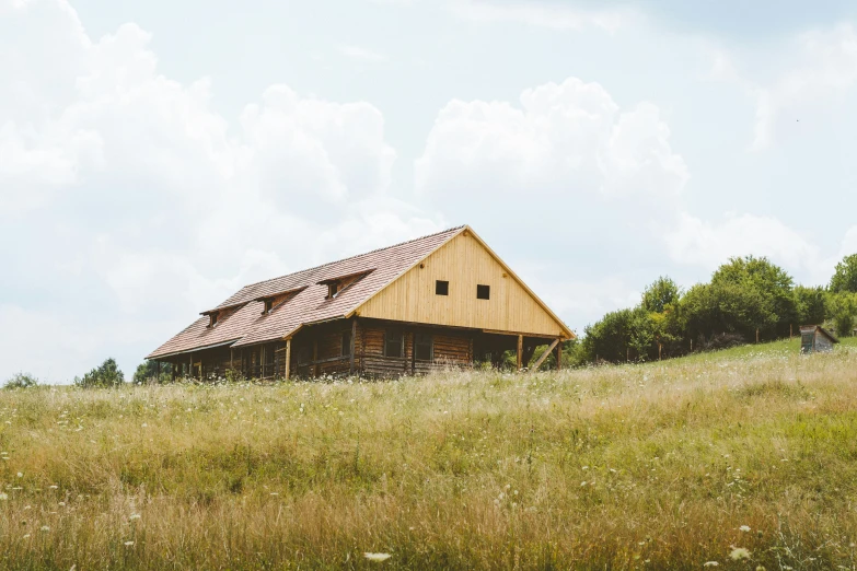 an old, abandoned cabin sitting on top of a hill