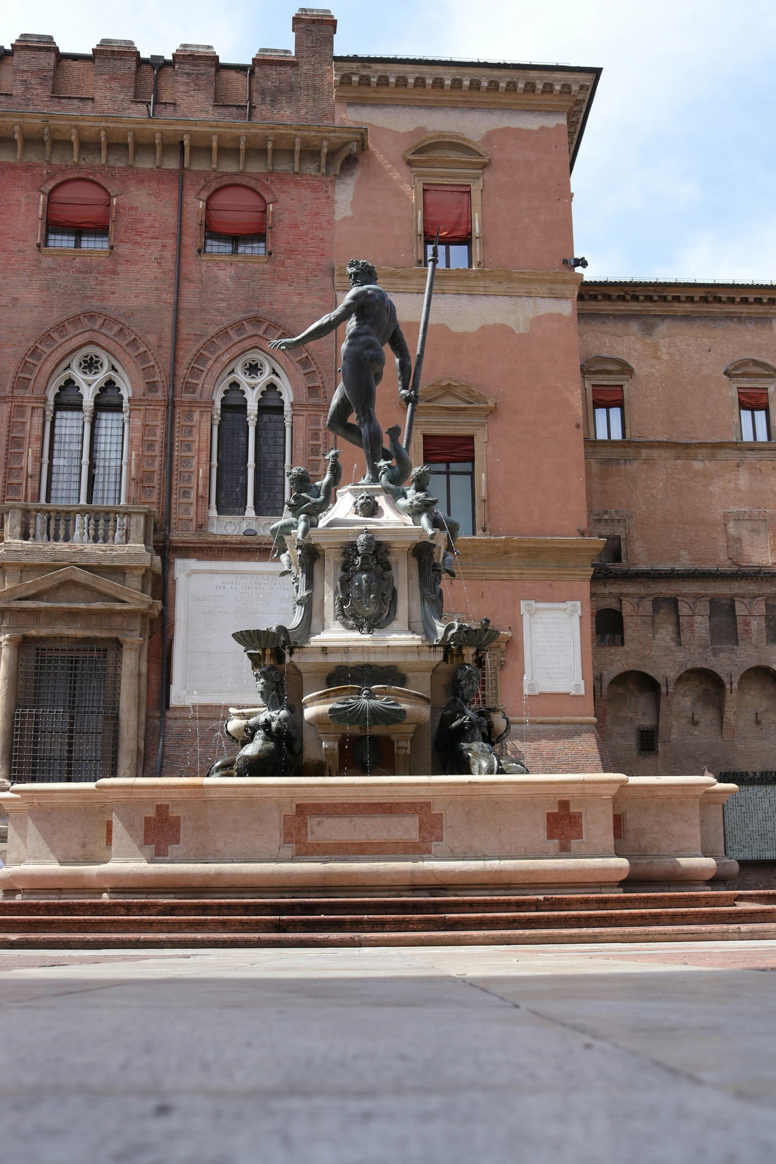 a large red building with a statue of a man in the center