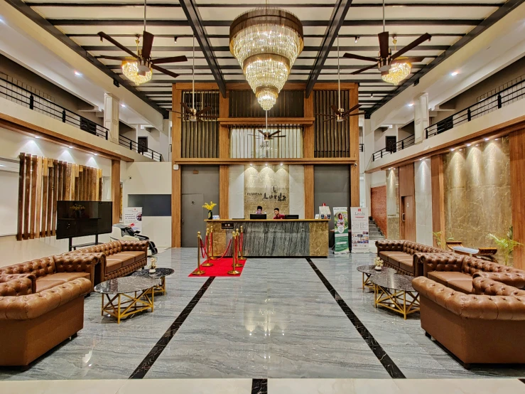 a lobby with couches, chandeliers and a bar