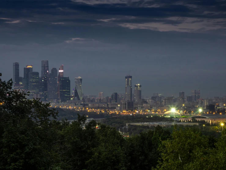 a city with tall buildings and light up lights at night