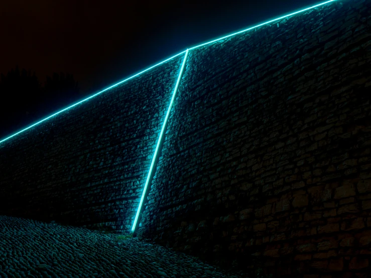 a large triangle of lights shining down on top of a building