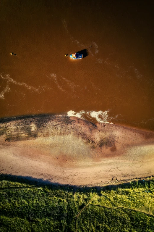 a small boat is in the water on the beach