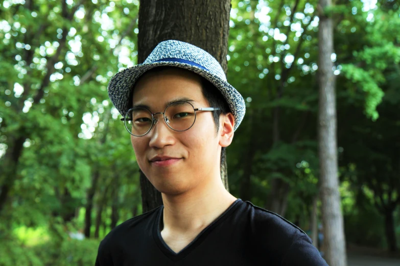 a man that is wearing glasses and a hat