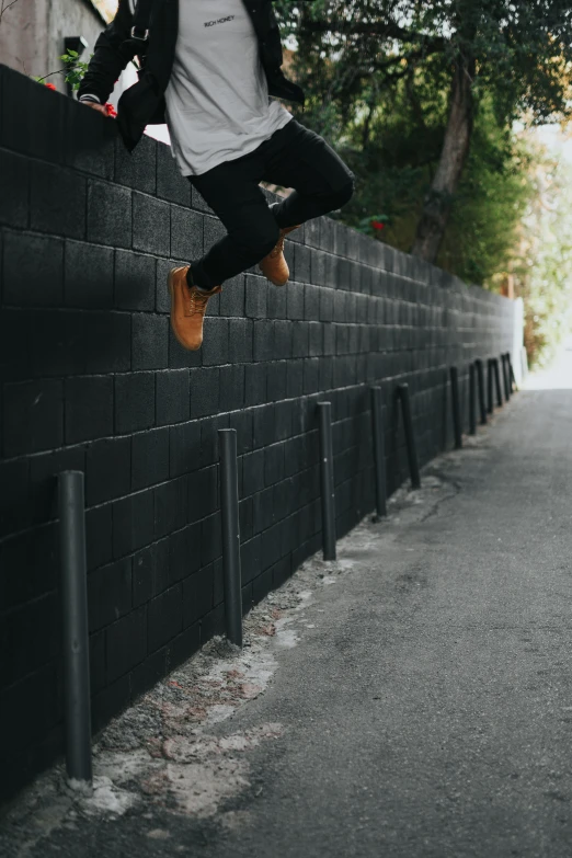the man is jumping in the air from a wall