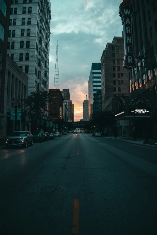 city street with cars at dusk time with sky