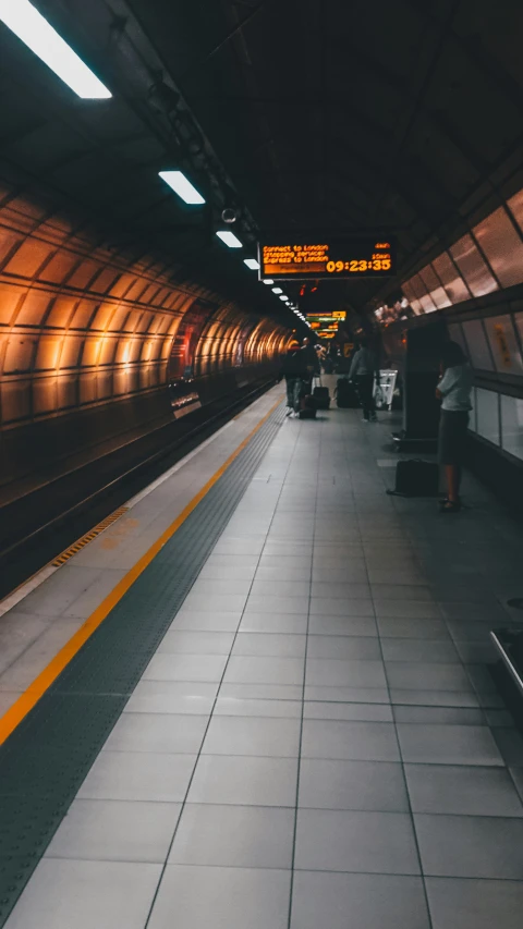 a long train platform with a long yellow line and yellow and black tracks