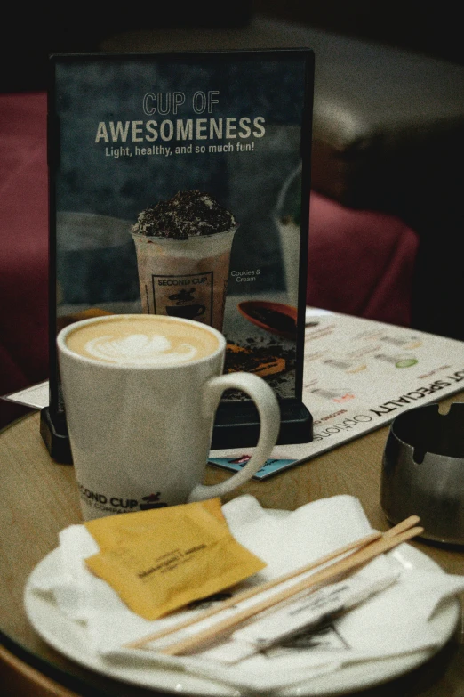 a cup of coffee sitting on top of a white plate