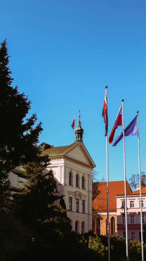 the tower is very large and has three flags on top