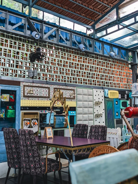 many colorful chairs with a table in a room