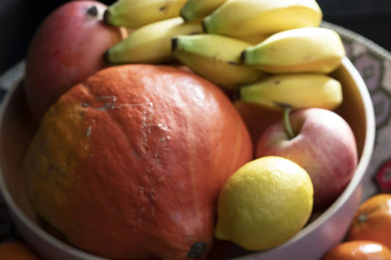 an arrangement of fruit on a floral pattern plate