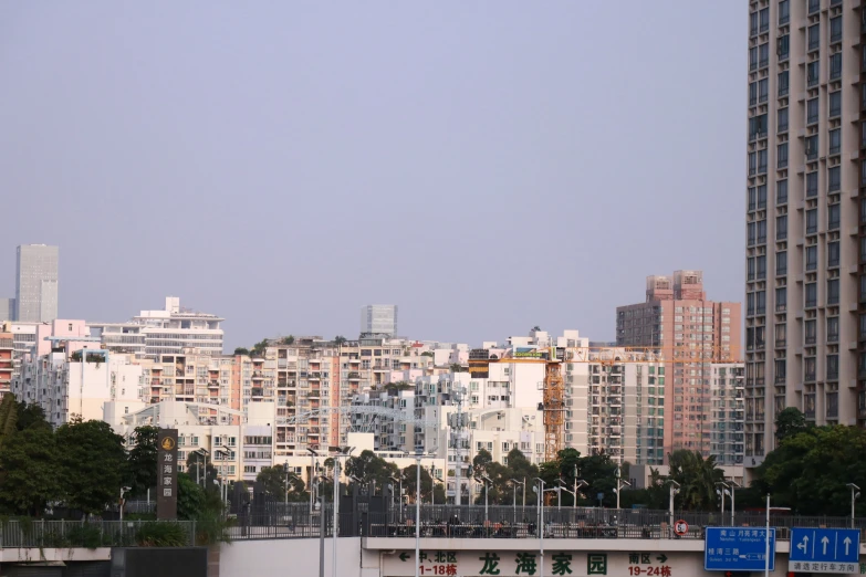 a large city skyline with tall buildings next to it