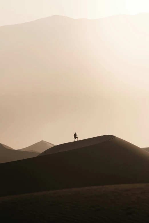 a person riding his bike down a hill in the desert