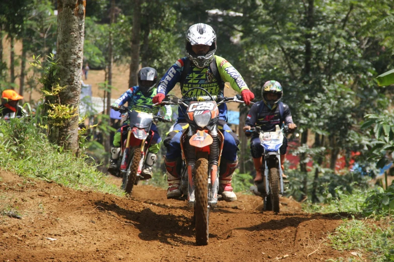 several people on motorcycles with helmets and numbers