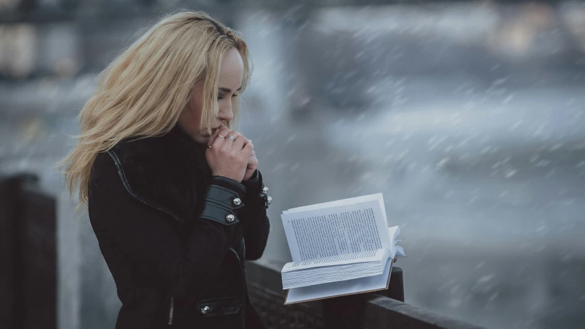 a woman with blonde hair wearing a black jacket