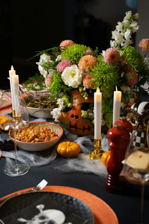 a table with a bunch of food, plates and glasses