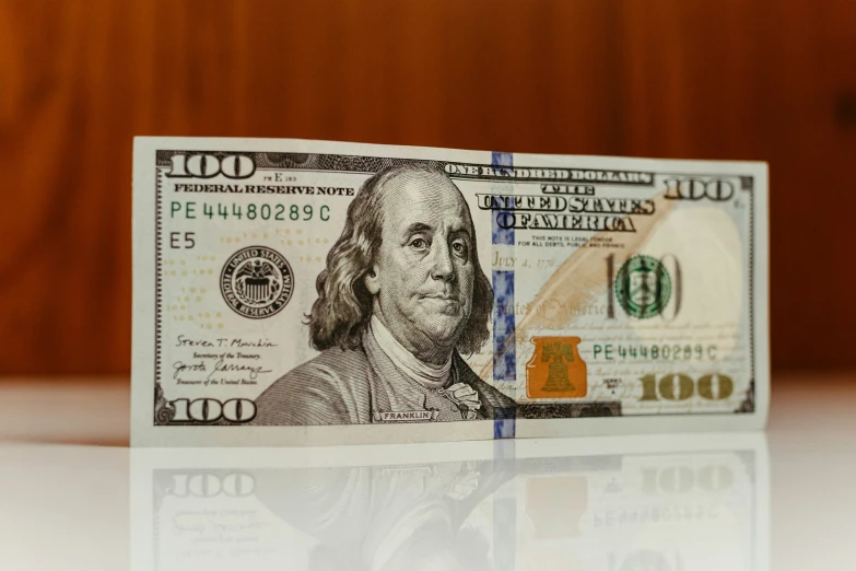 a twenty dollar bill sitting on top of a counter