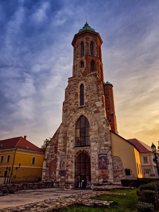 an old church steeple sits high in the sky