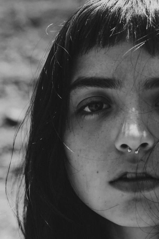 a close up of a woman with nose piercing