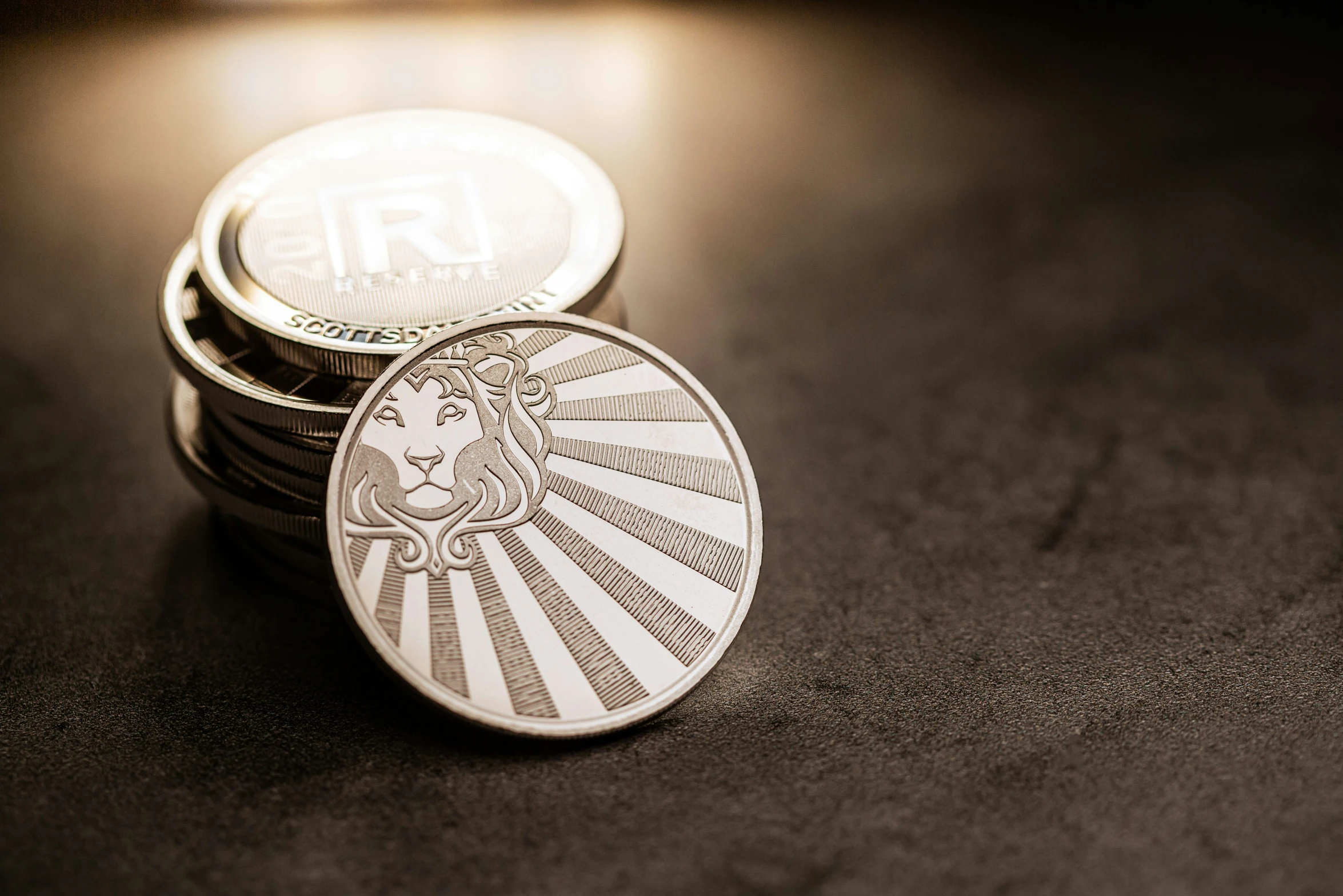 a stack of silver metal round coasters