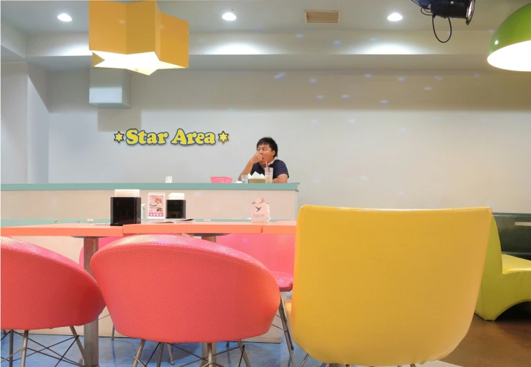 an office has neon furniture and a sign on the wall