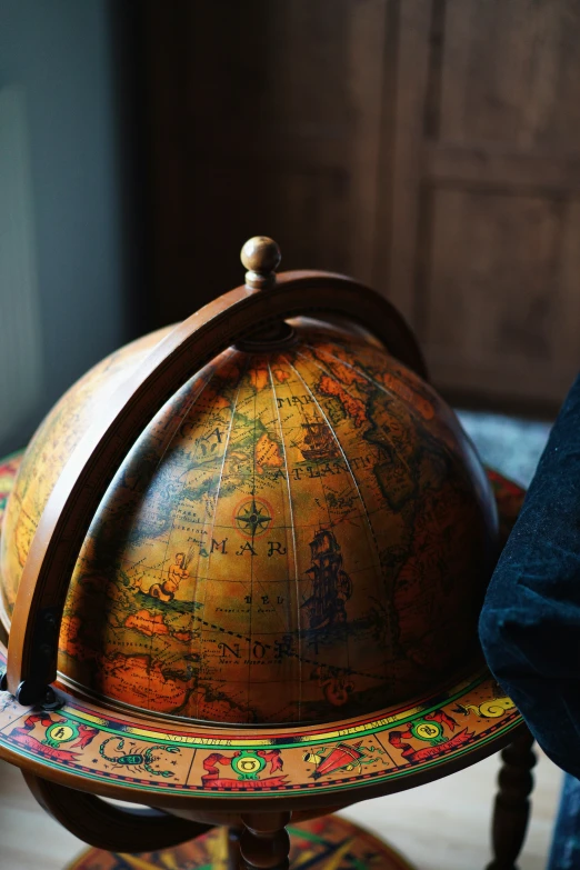 a small wooden globe with different colors on it