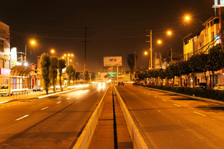 a city street lined with many buildings lit up at night