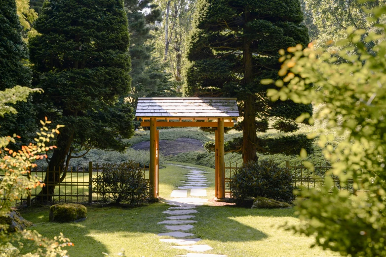 a beautiful park with a gazebo and lush green bushes