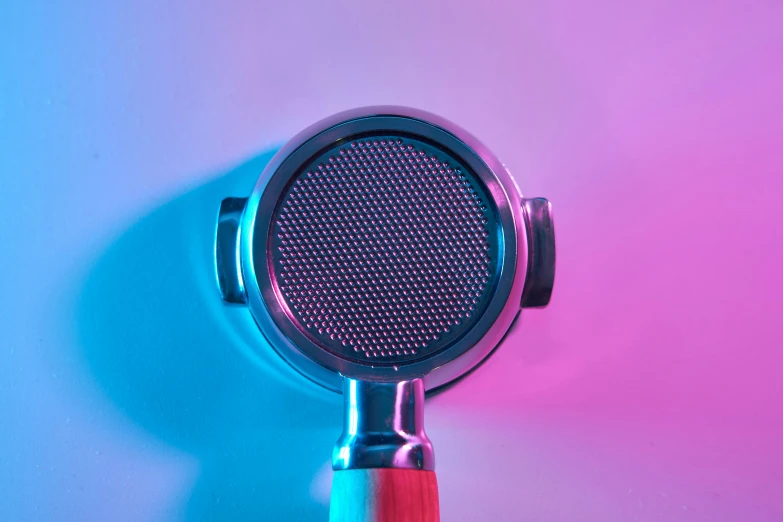 a blue and red microphone stands on the wall