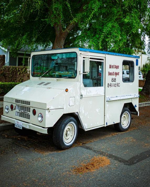 an old white truck with graffiti on the side