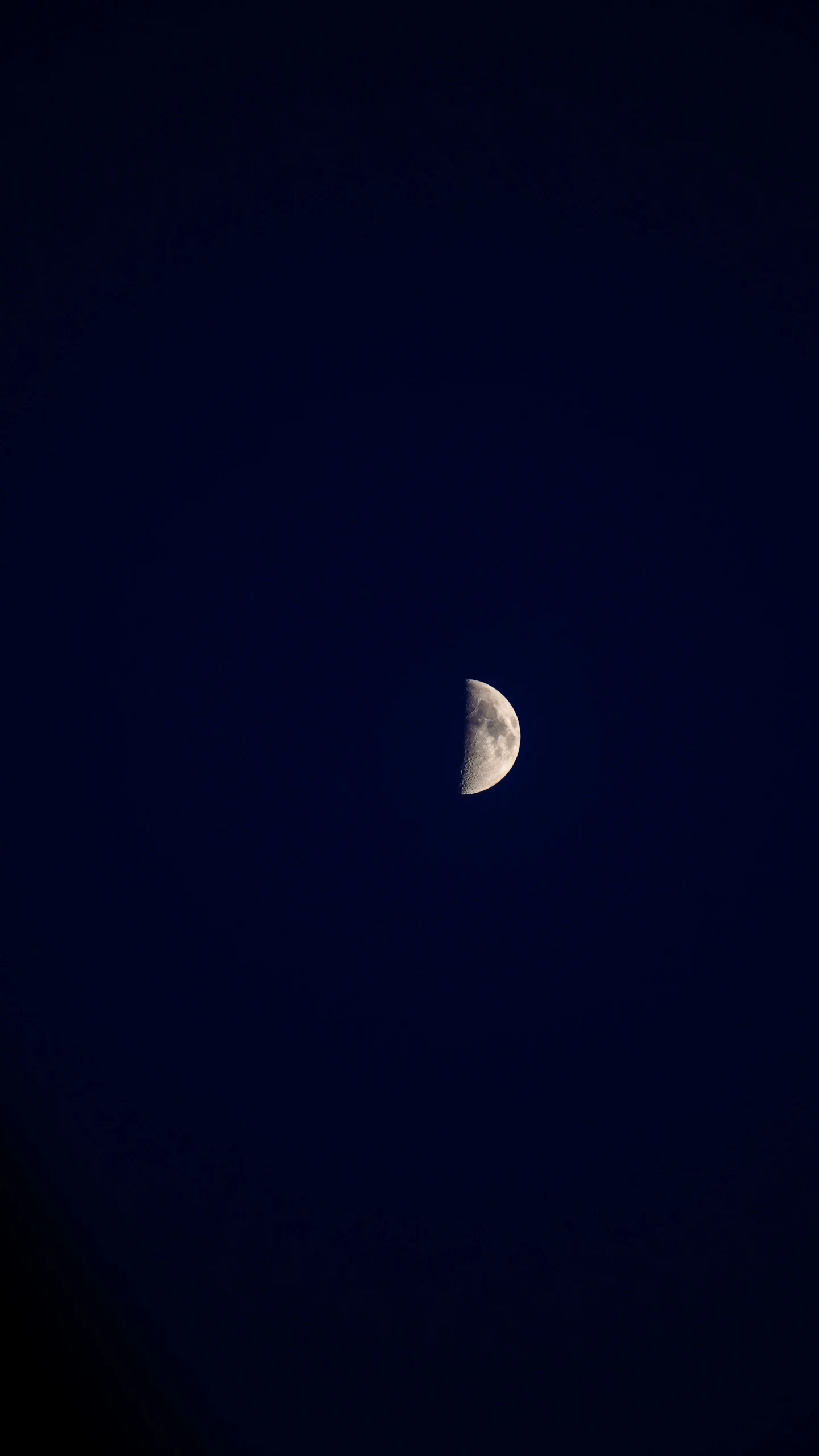 a partial moon seen from an airplane during the night