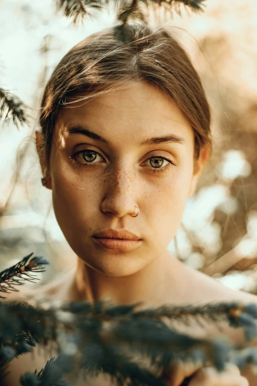 the girl is posing in front of trees