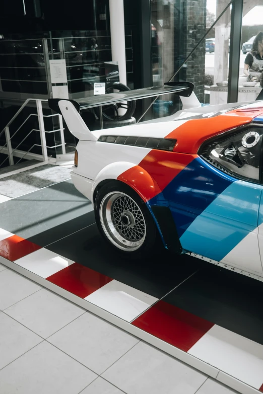 a colorful car sitting on top of a checkered floor