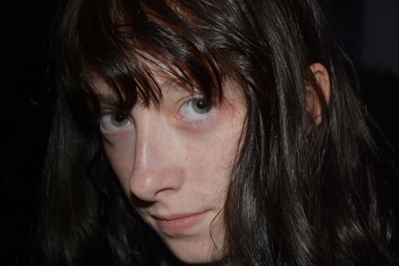 a young woman with freckled hair and freckles on her face