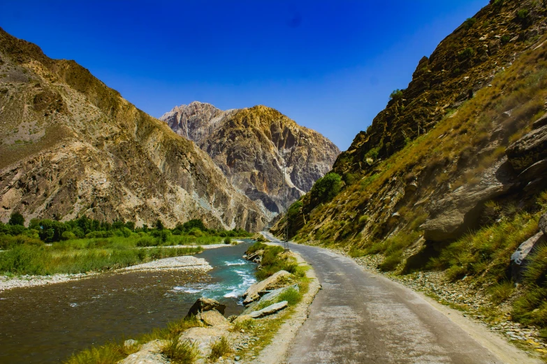 the road is winding with a very tall mountain